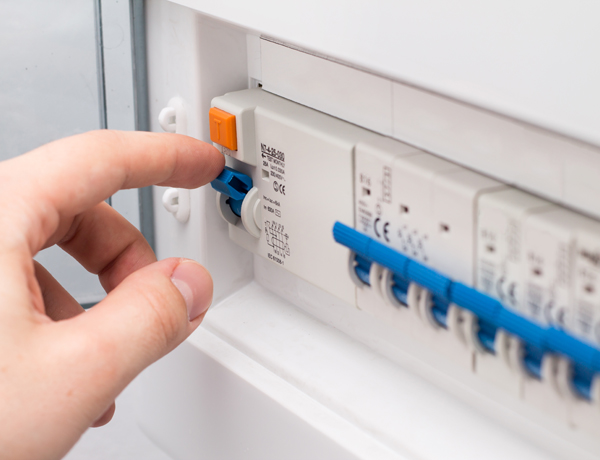 Man turning on the fuse box